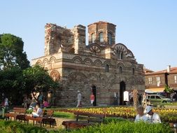 people resting in park at medieval Church of Christ Pantocrator, bulgaria, nesebar