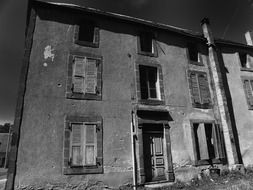 old building with closed windows and door, france