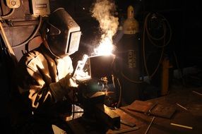 Welder in the mask at work