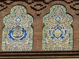 ceramic tiles ornament at brick wall, spain. madrid