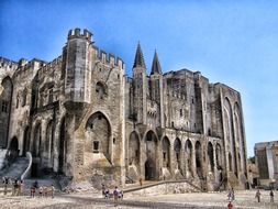 tourists looking at palais des papes, france, avignon