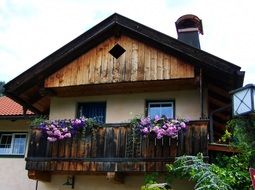 flowers on wooden balcony of old building