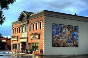 indian girl, colorful mural on wall of shop building, canada, alberta