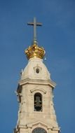 steeple of Basilica of Our Lady of the Rosary with cross at top of crown at sky, portugal, SantarÃ©m