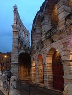 bicycle parked at Arena, ancient Roman amphitheatre, in dusk, italy, Verona