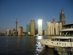 boat on water at skyline of modern city, china, shanghai