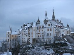 Chateau de Neuchatel, aged castle on hill at winter, switzerland