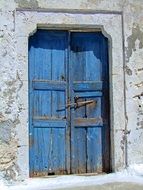 closed weathered blue painted wooden door