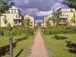 walk path to new buildings in residential complex, germany, brandenburg