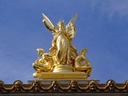 golden sculpture outside of a building in Paris