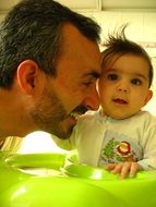 smiling father with baby daughter, family happiness