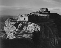 black and white photo of a building standing on rocks in arizona