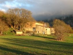 stone house on a green field in Spain