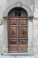 Entrance wooden door with forged handles