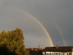 landscape of colorful half rainbow on a dark sky