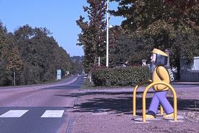 figure of schoolboy by the crosswalk