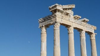 historical Roman ruins with columns against the blue sky