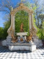 golden neptune, fountain in garden, spain, madrid