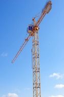 picture of one tall construction crane against a blue sky