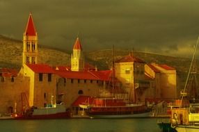 boats on water in scenic old town near the hills, croatia, dalmatia, trogir