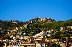 city on a hill under a blue sky