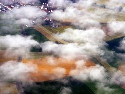 white clouds over countryside, view from airplane