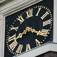 classic gloden clock on facade, amsterdam
