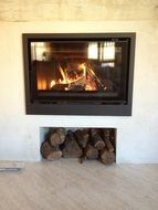 burning fireplace with firewood in the house
