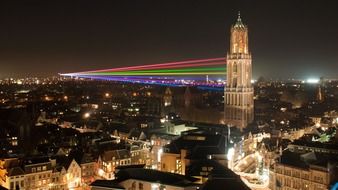 landscape of laser beam against the skyscraper at night