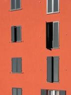 windows with gray shutters on a red house, switzerland