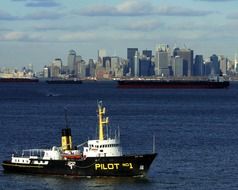 pilot boat in Sea harbor skyscrapers scene