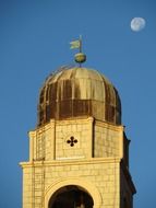 moon over church dome in the early morning