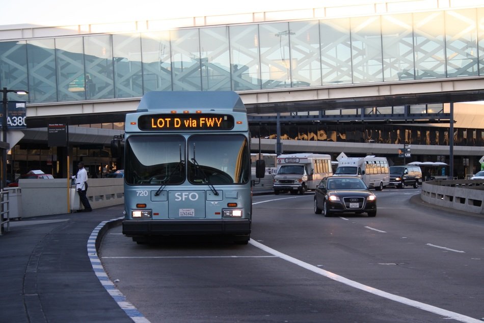 grey bus on road in city