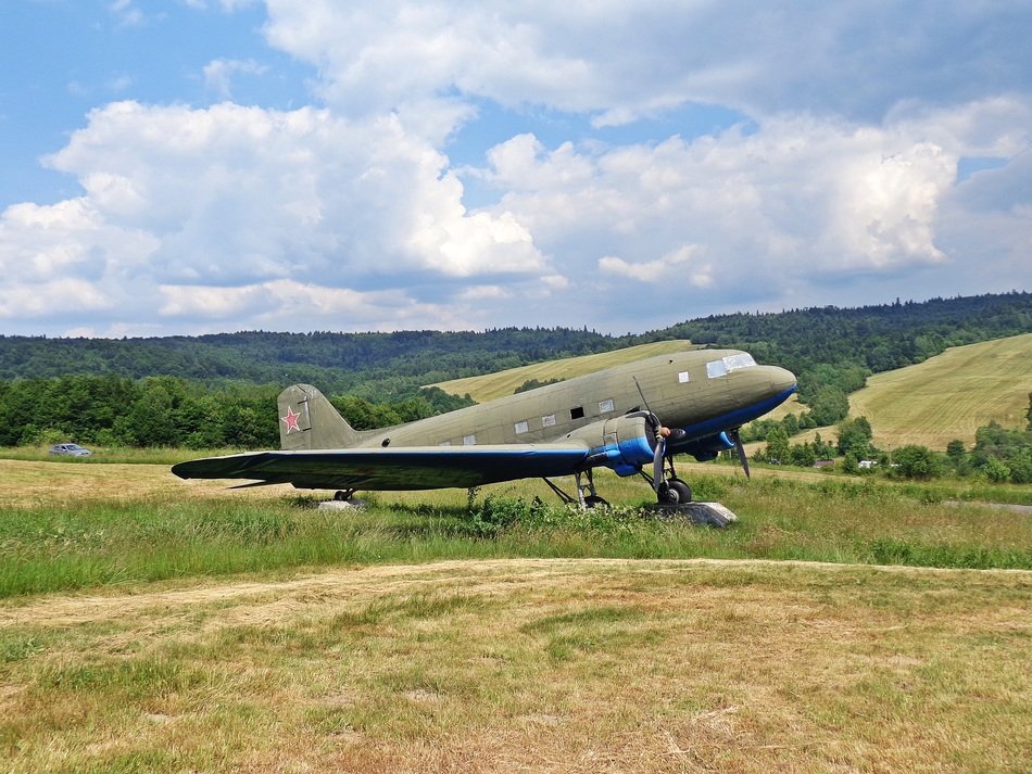 World War II Soviet fighter aircraft on meadow in summer countryside