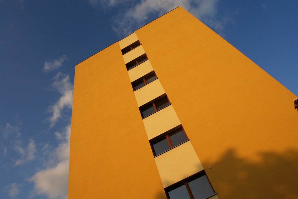 yellow wall of modern building on the sky background