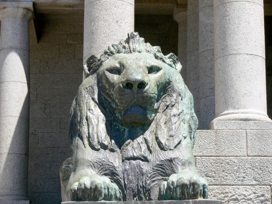 laying lion, ancient stone sculpture at facade