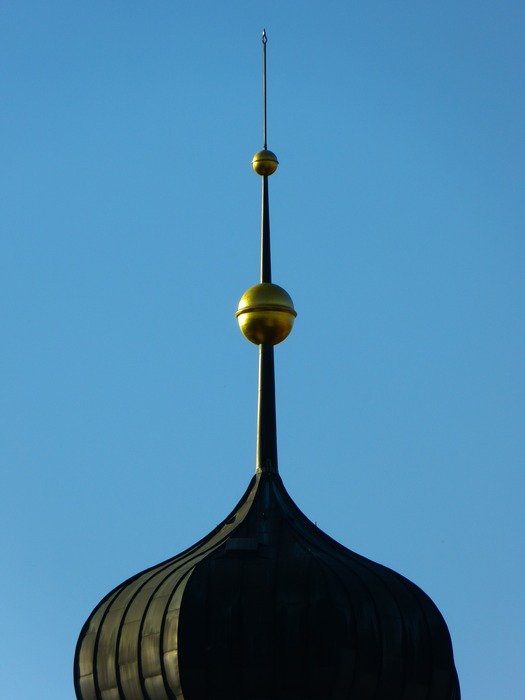 spire above onion helm at blue sky