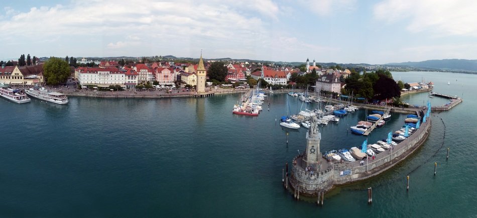 bavarian lion at harbour entrance in view of old town, germany, lindau