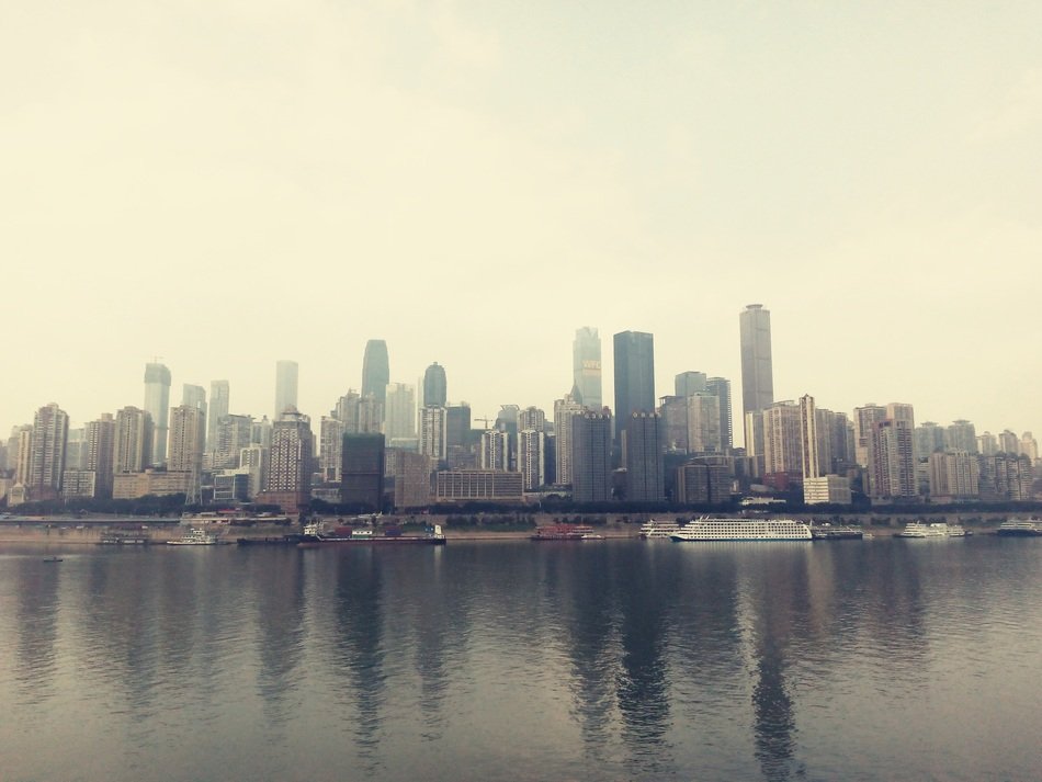 downtown skyline mirroring on river, china, chongqing