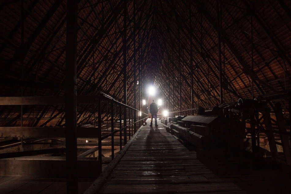 man stays on wooden walk path under roof construction of ulm cathedral, germany, münster,