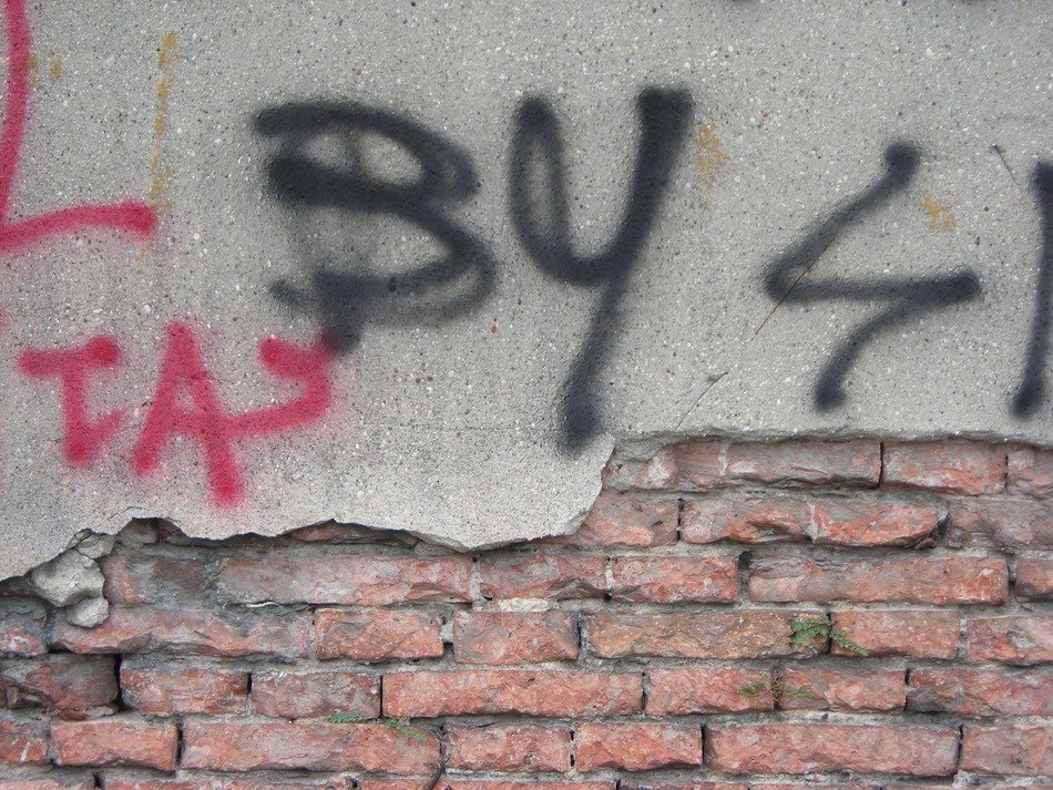 old wall with graffity on plaster