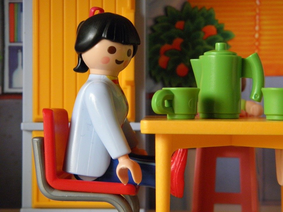 doll at breakfast table, colorful toys