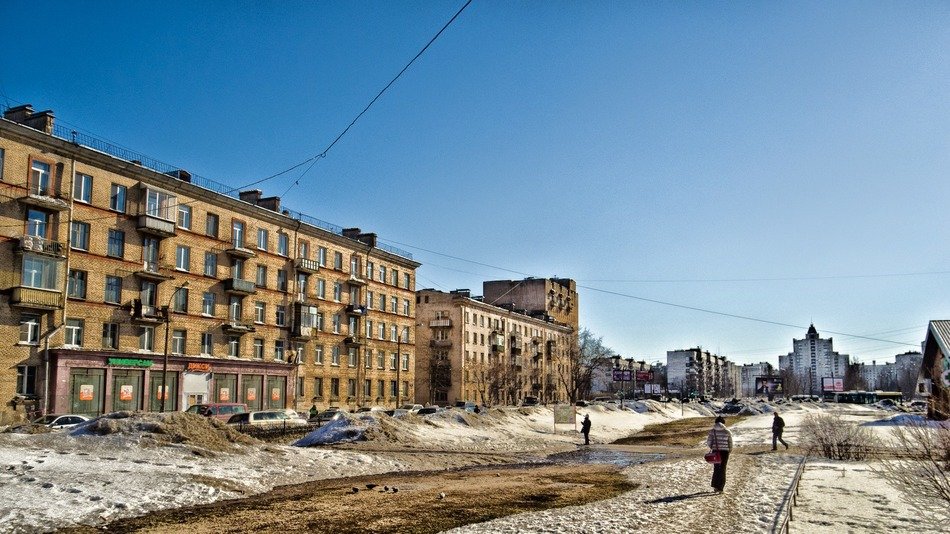 people walking on street at five-storey houses at winter, russia, saint petersburg