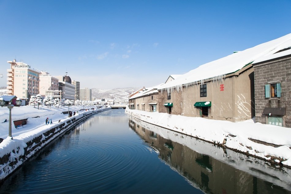 embankment of canal in town at snowy winter