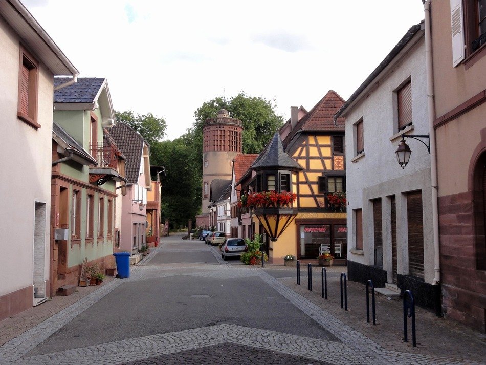 alley with old buildings and tower, france, reichshoffen