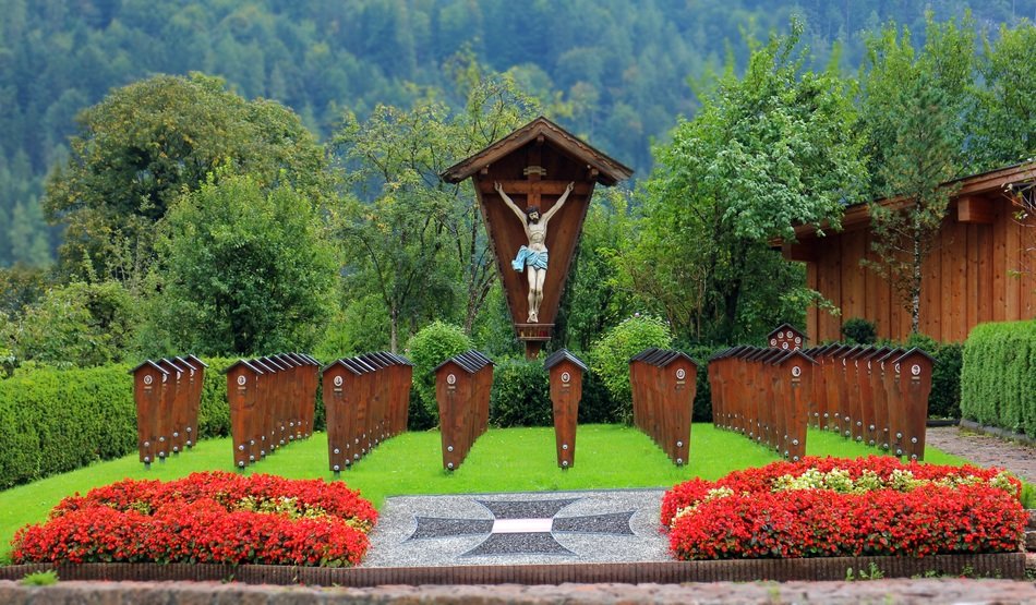 carved wooden crucifixion on cemetery in countryside, world war ii memorial