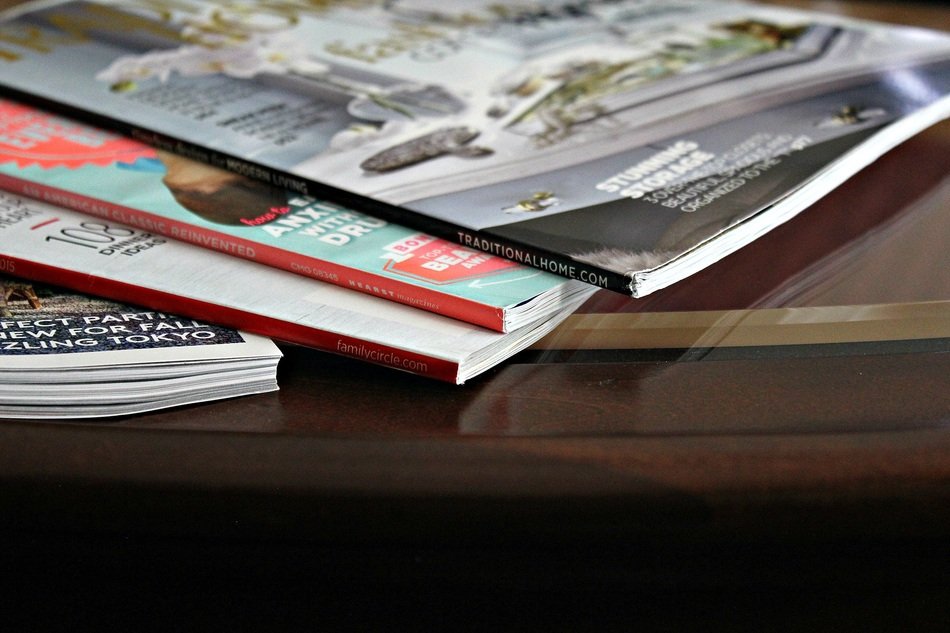 pile of closed magazines on desk