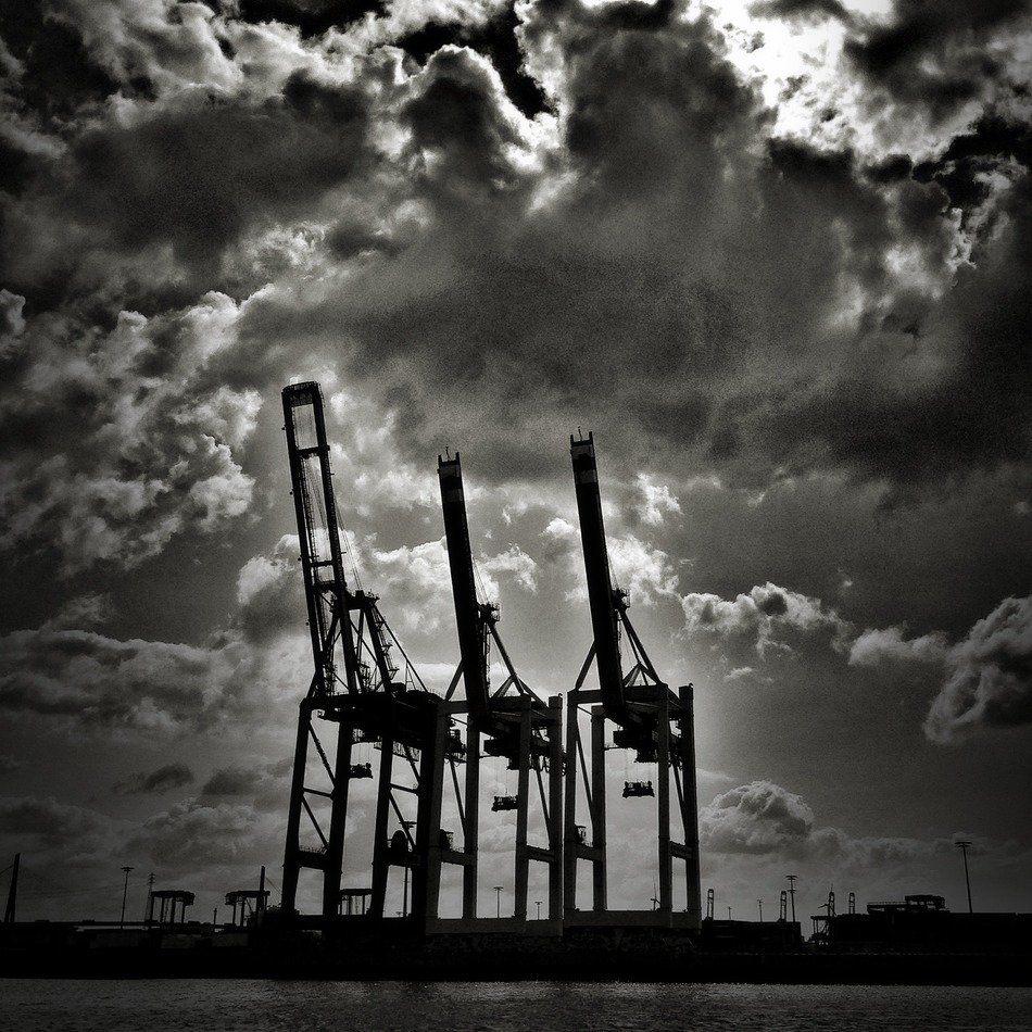Container cranes in port at sky, germany, hamburg