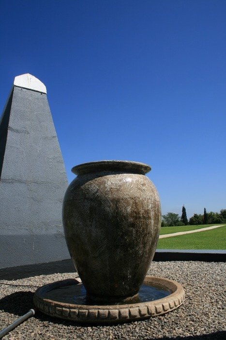 fountain with large brown stone urn at obelisk