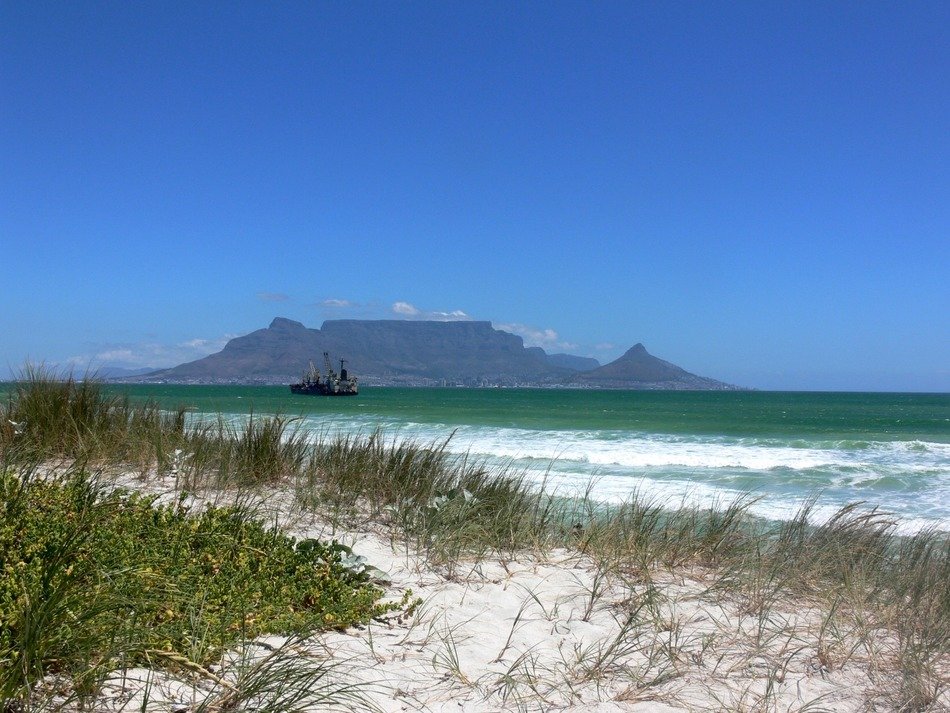 sand dunes at sea in view of distant table mountain, south africa, cape town, Bloubergstrand